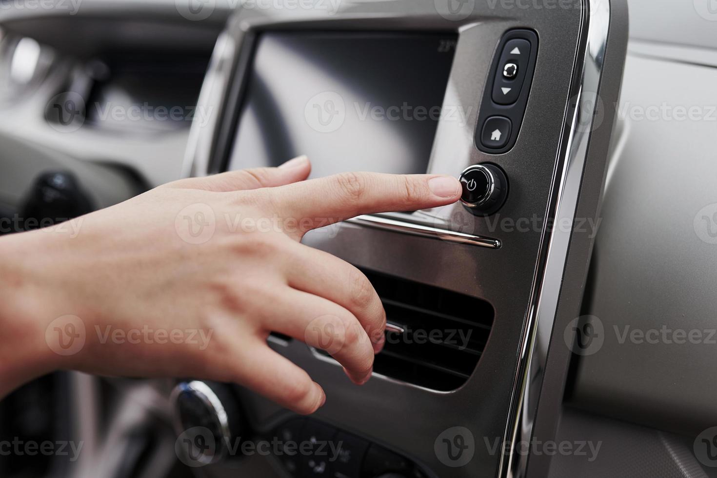 Female driver inside of brand new modern electrical car. Particle view photo