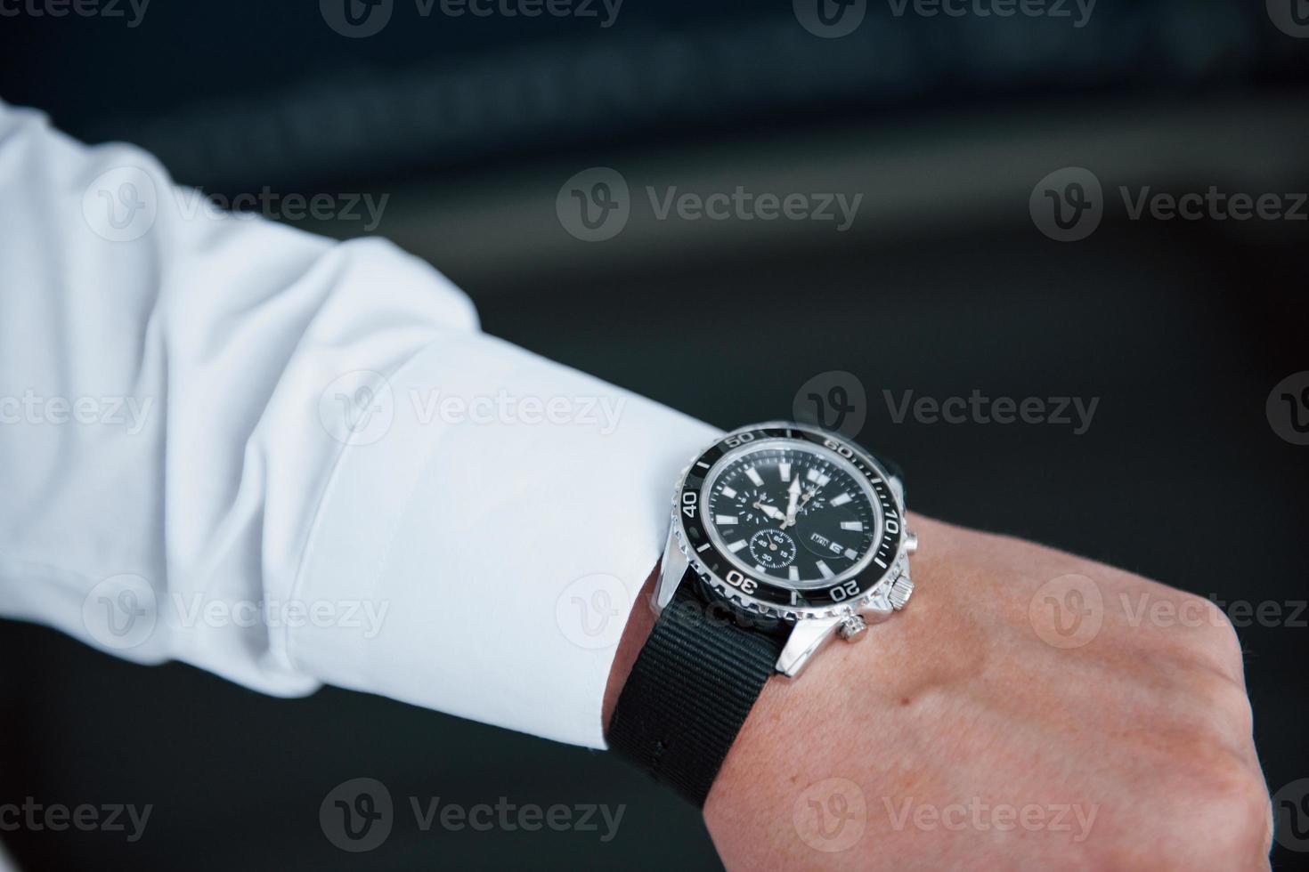 Close up photo of man's hand in suit with luxury watch