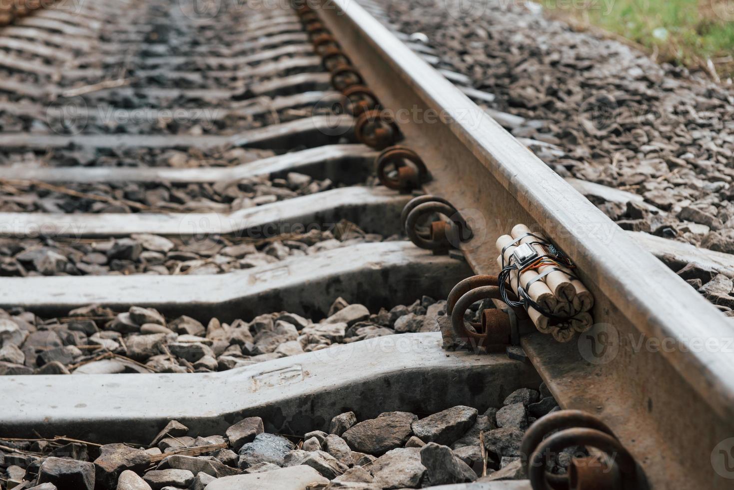 Timebomb on the railway at daytime outdoors. Conception of terrorism and danger photo