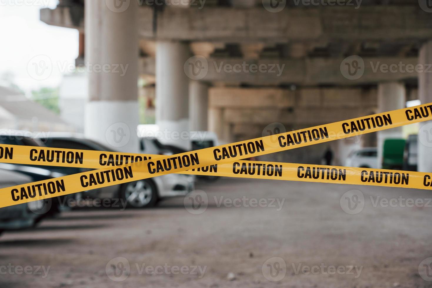 Many of vehicles. Yellow caution tape near the car parking lot at daytime. Crime scene photo