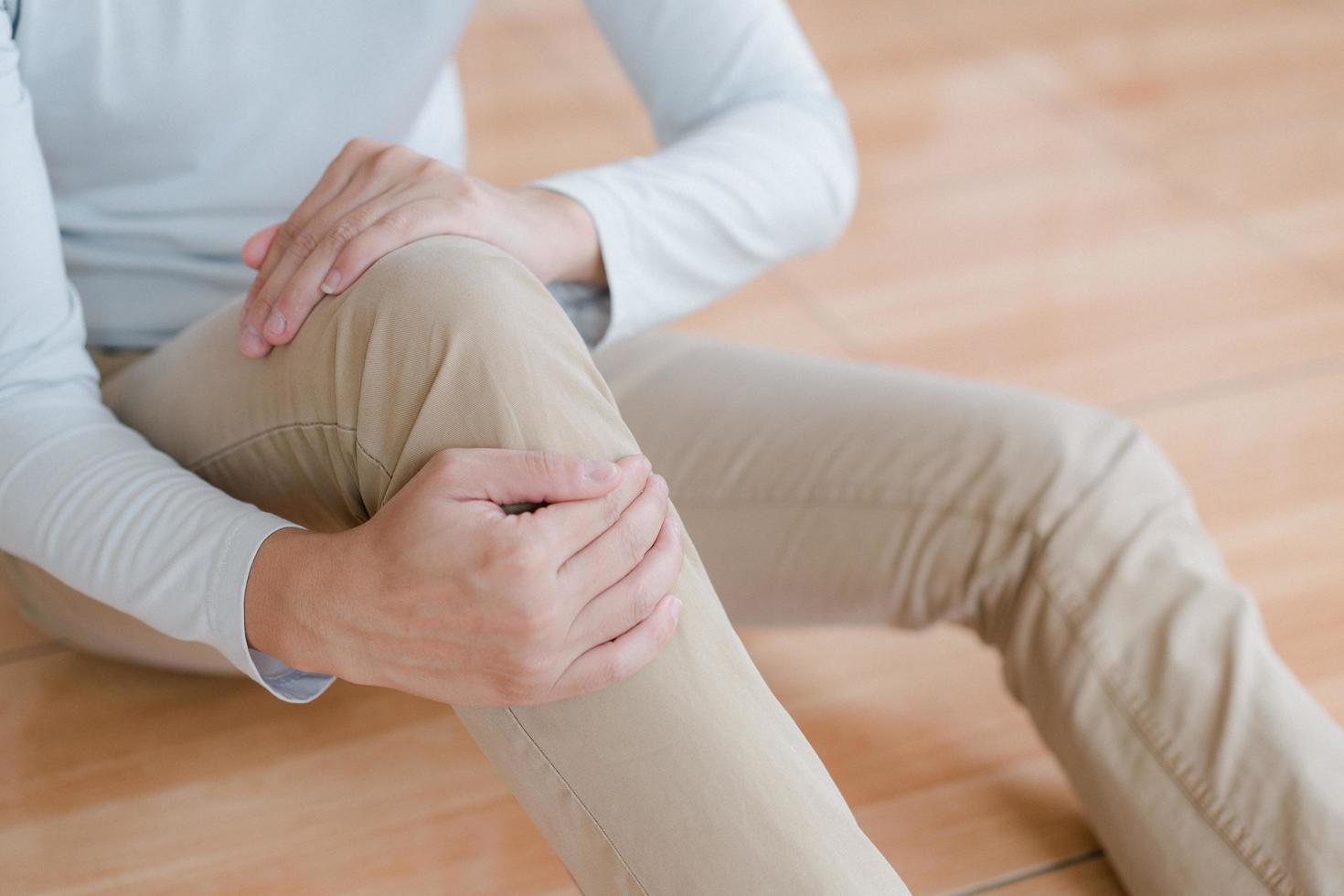 man suffering from pain in knee at home, closeup , healthcare concept photo