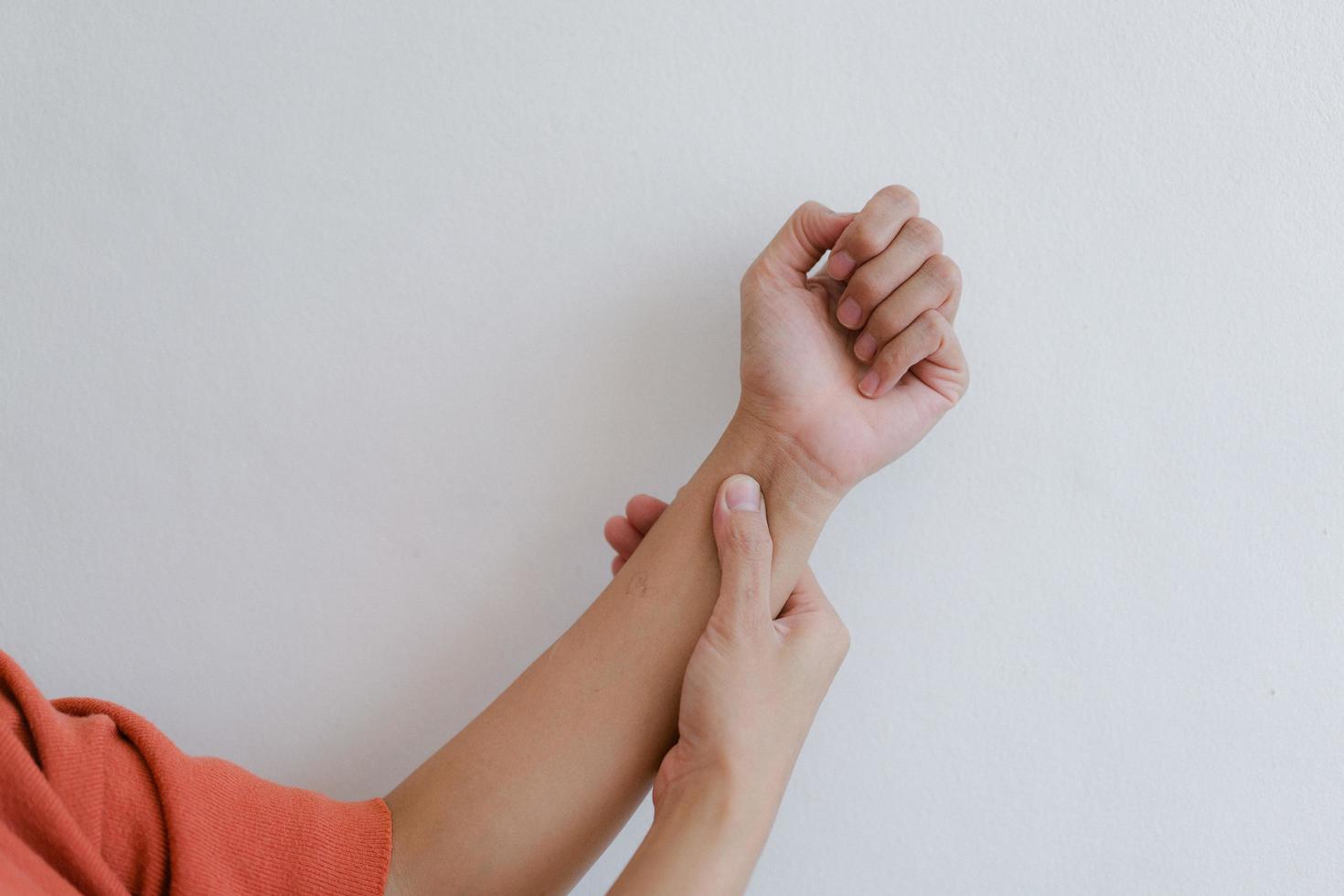 Closeup of hand with hand pain in palm isolated on gray wall background. photo