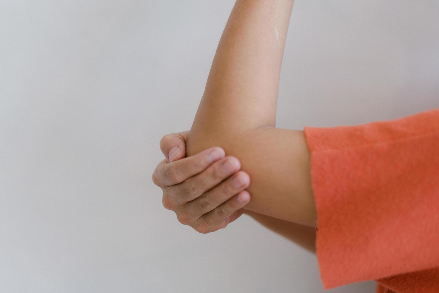 Closeup of hand with hand pain in palm isolated on gray wall background. photo