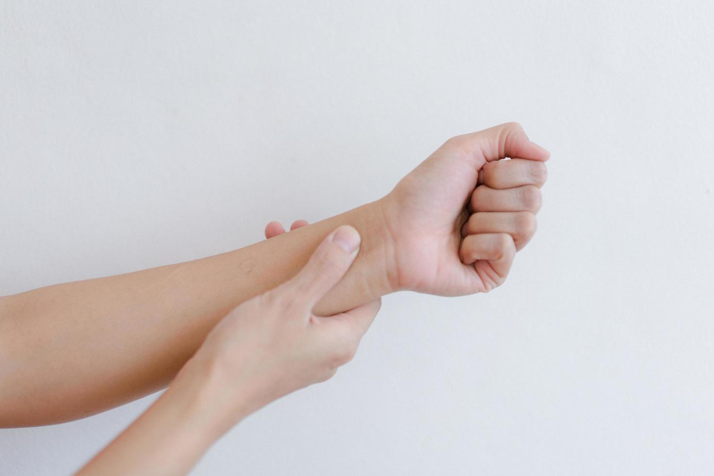 Closeup of hand with hand pain in palm isolated on gray wall background. photo