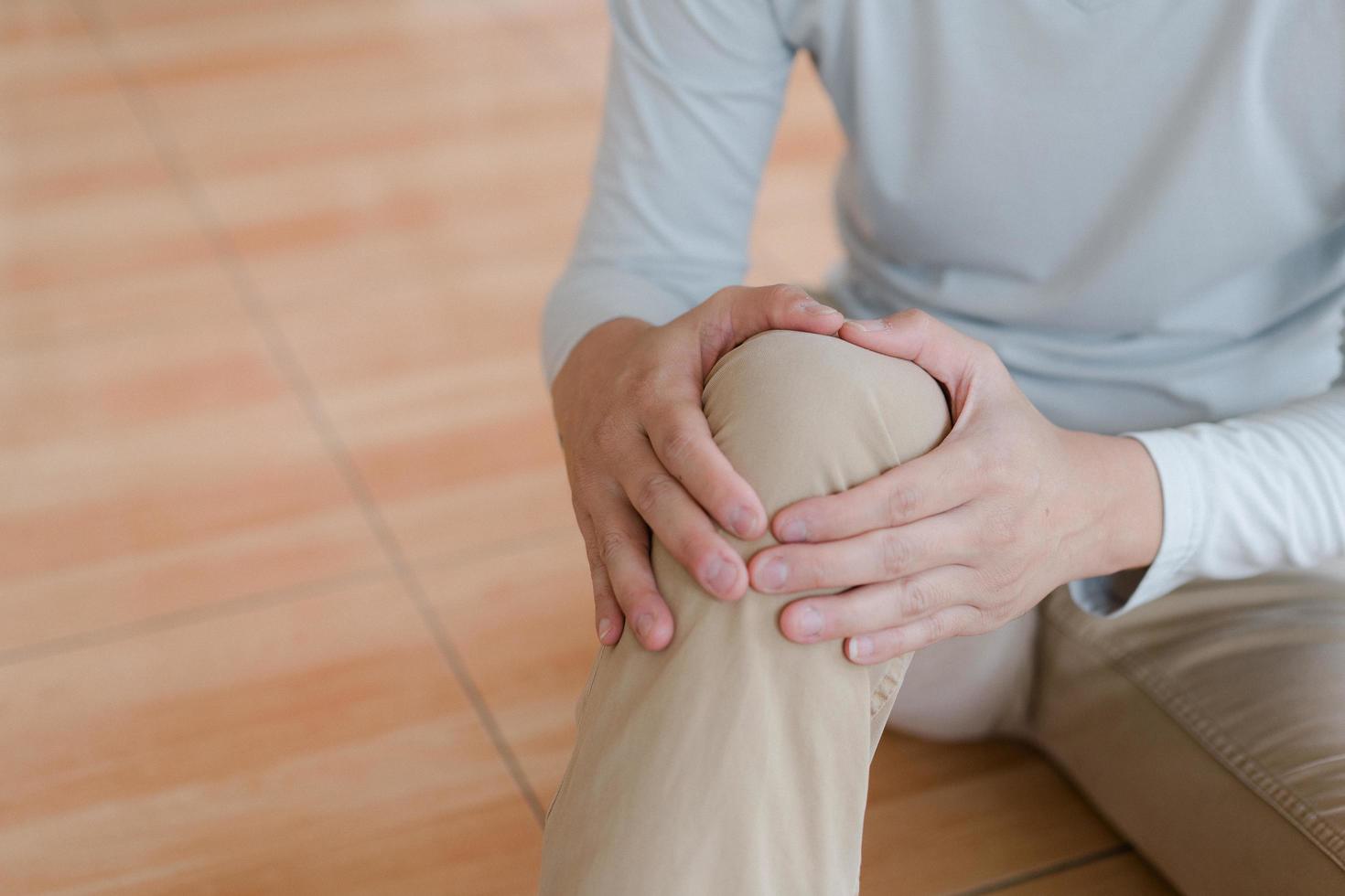 man suffering from pain in knee at home, closeup , healthcare concept photo