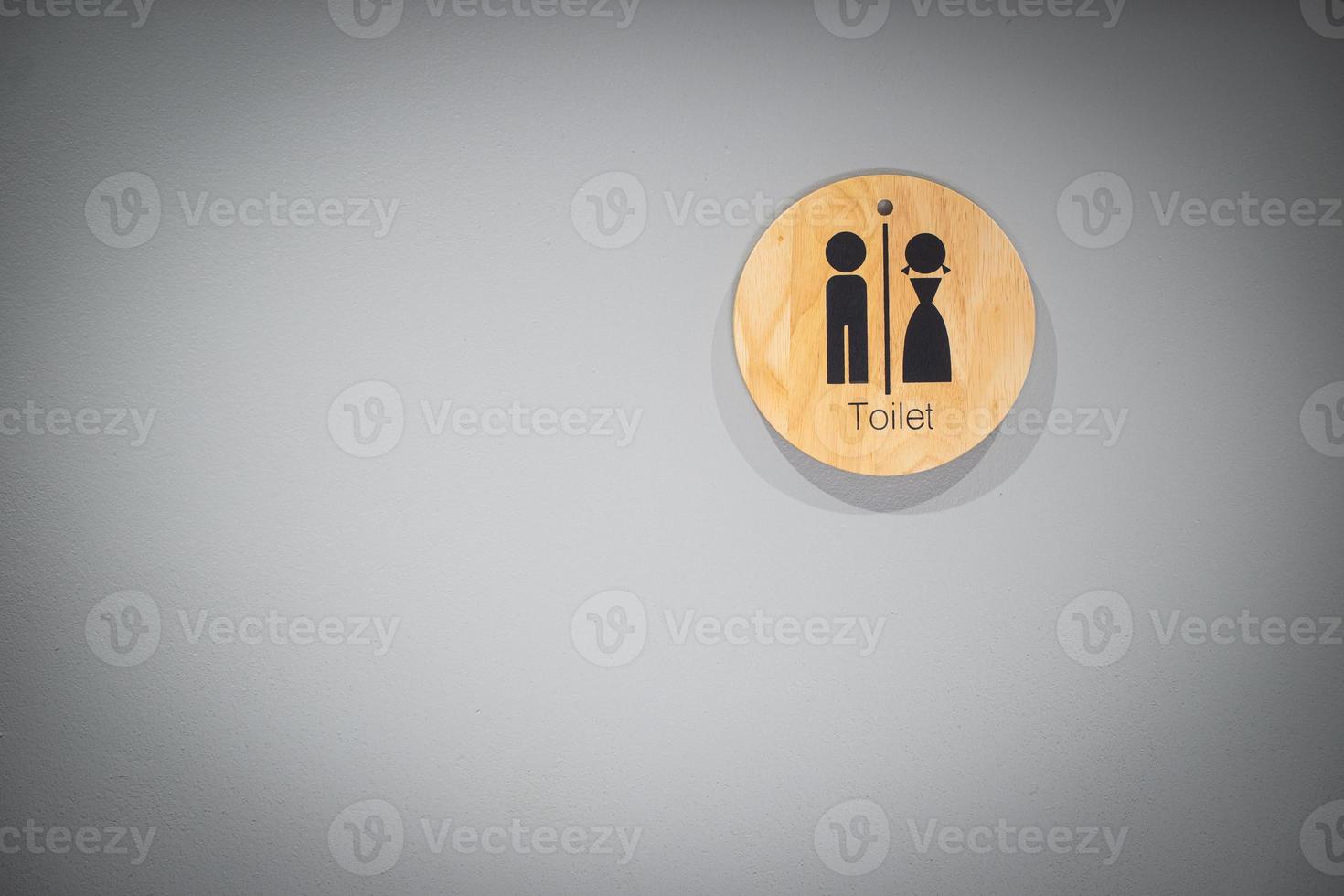 Toilet sign on wall photo