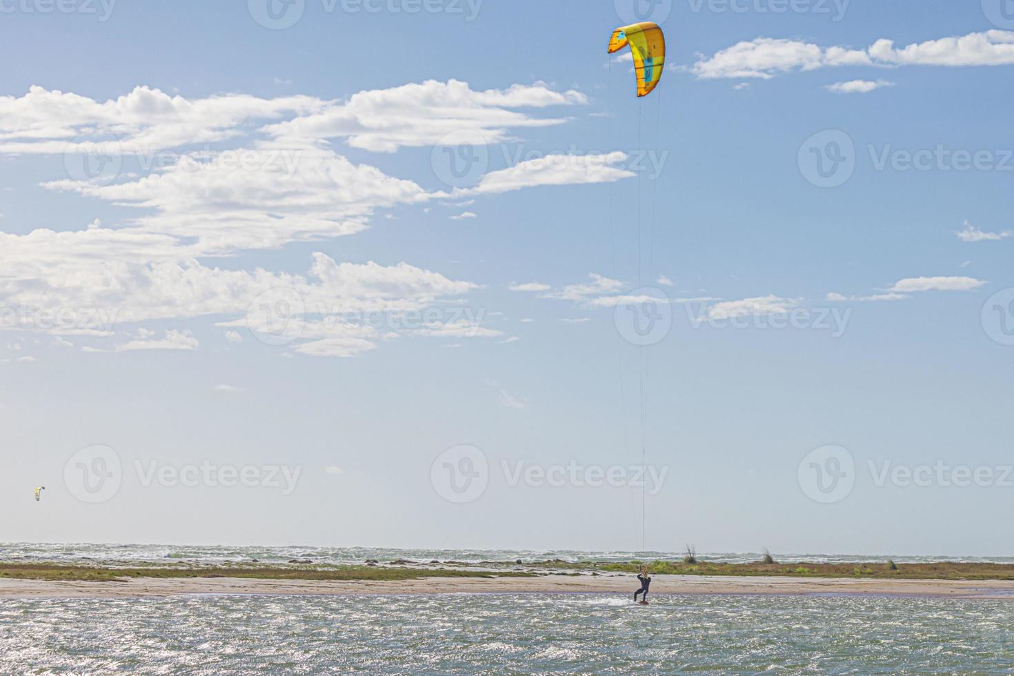 Picture of kitesurfers in stormy weather and sunshine in Florida photo