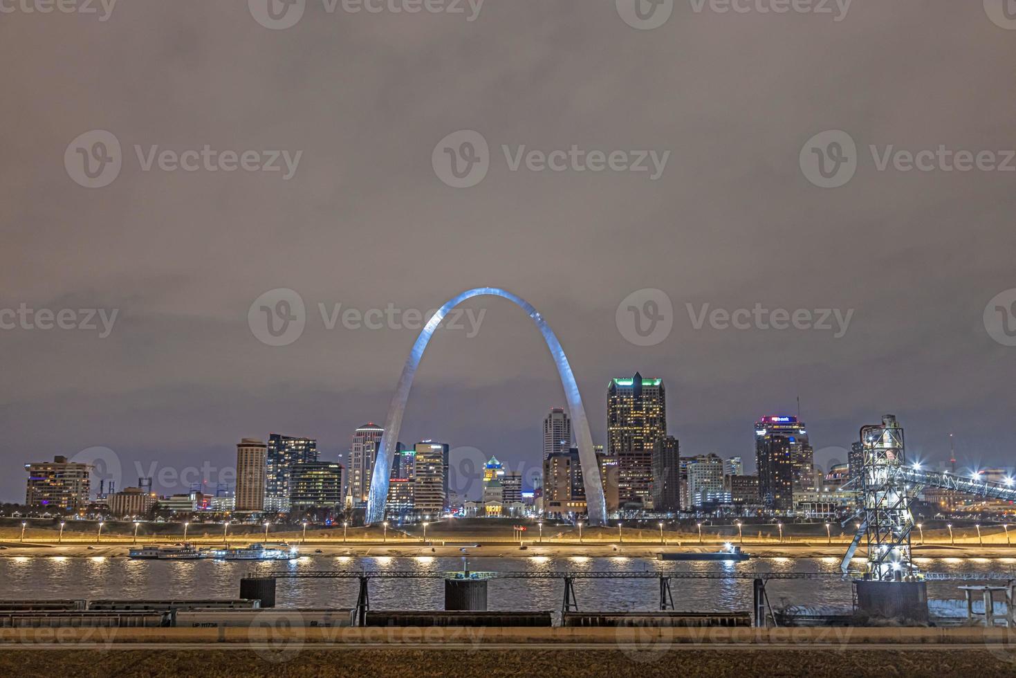 Panoramic picture over the skyline of St. Louis and Mississippi river with Gateway Arch at night photo