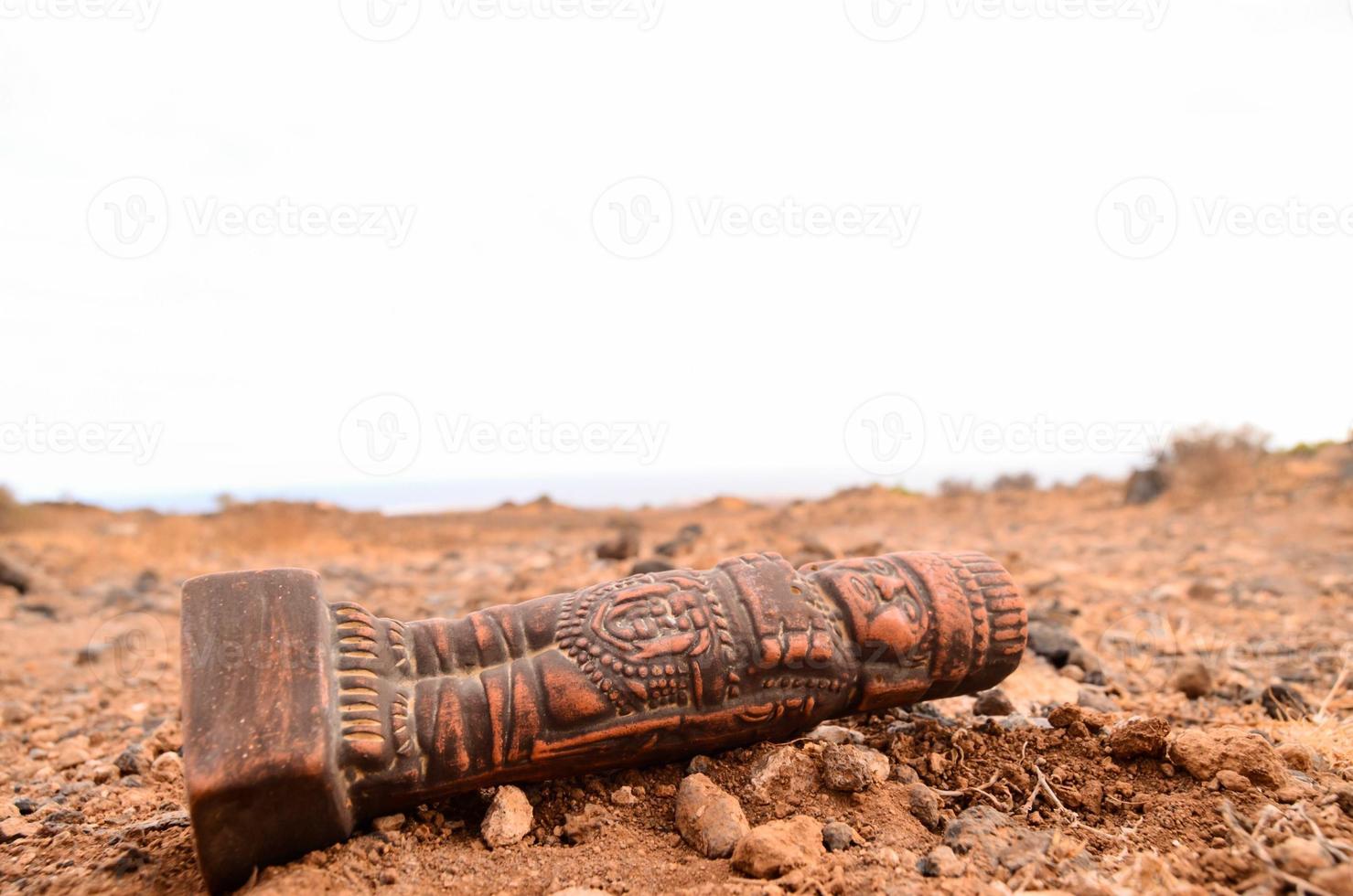 Pre Columbian figurine on the ground photo