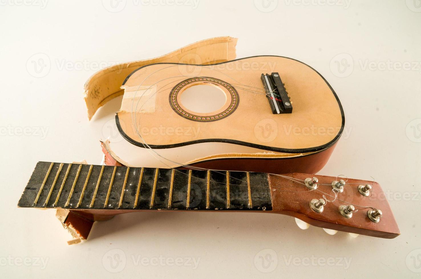 Broken acoustic guitar photo