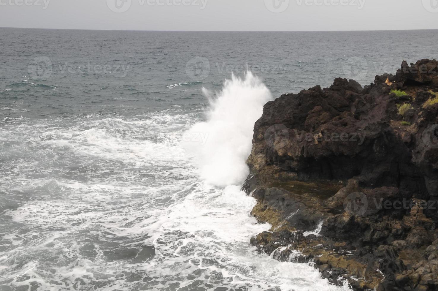 Waves hitting the rocks photo