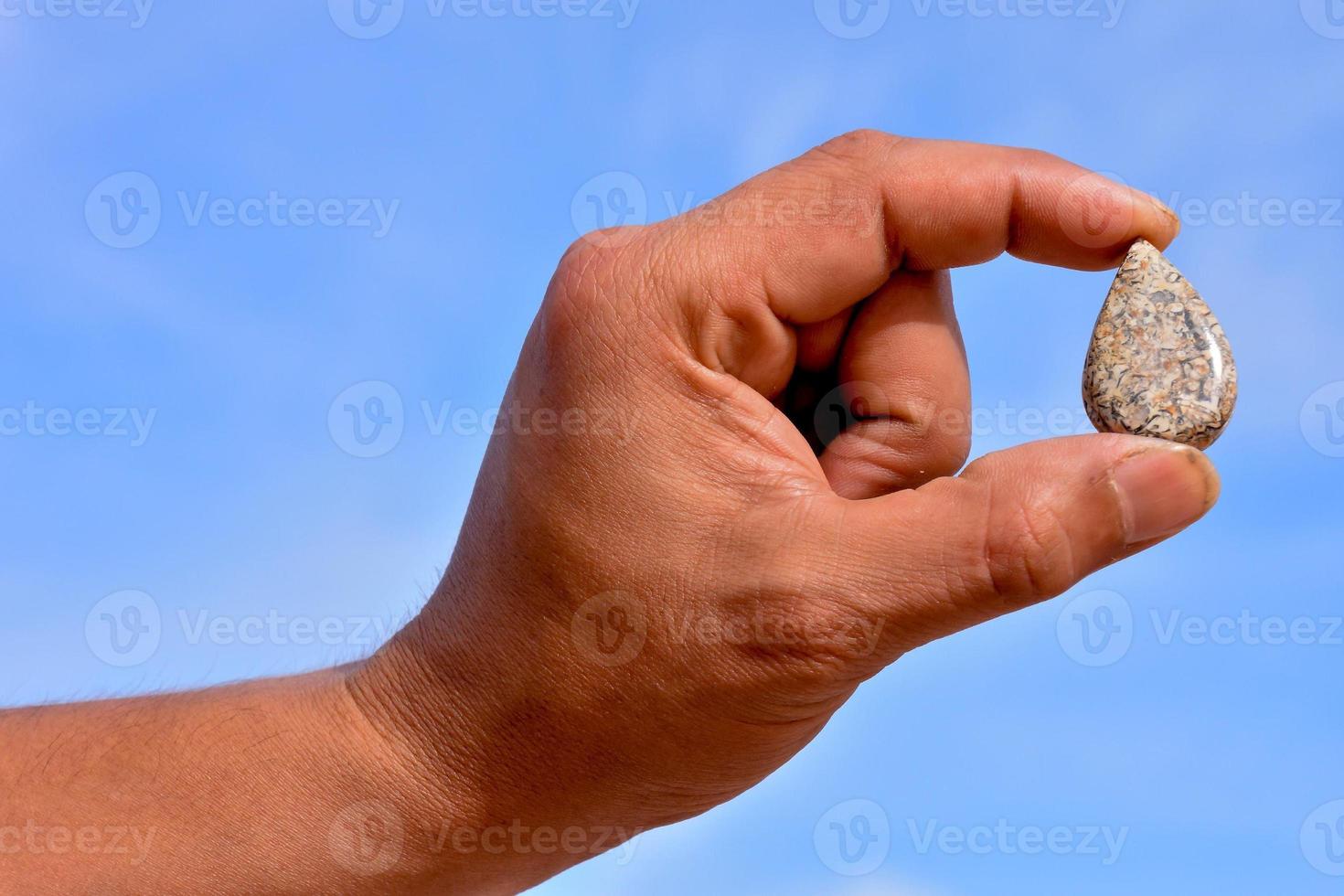 Hand holding a gemstone photo