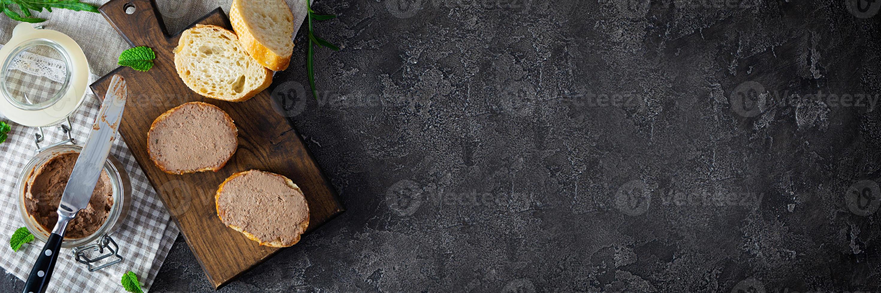 Sandwich with chicken liver pate on dark background. Top view photo