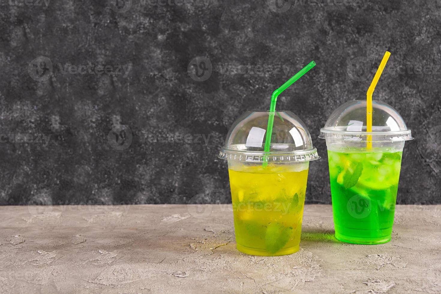 Cold summer lemonade with ice, lemon and mint. Cocktail to go photo