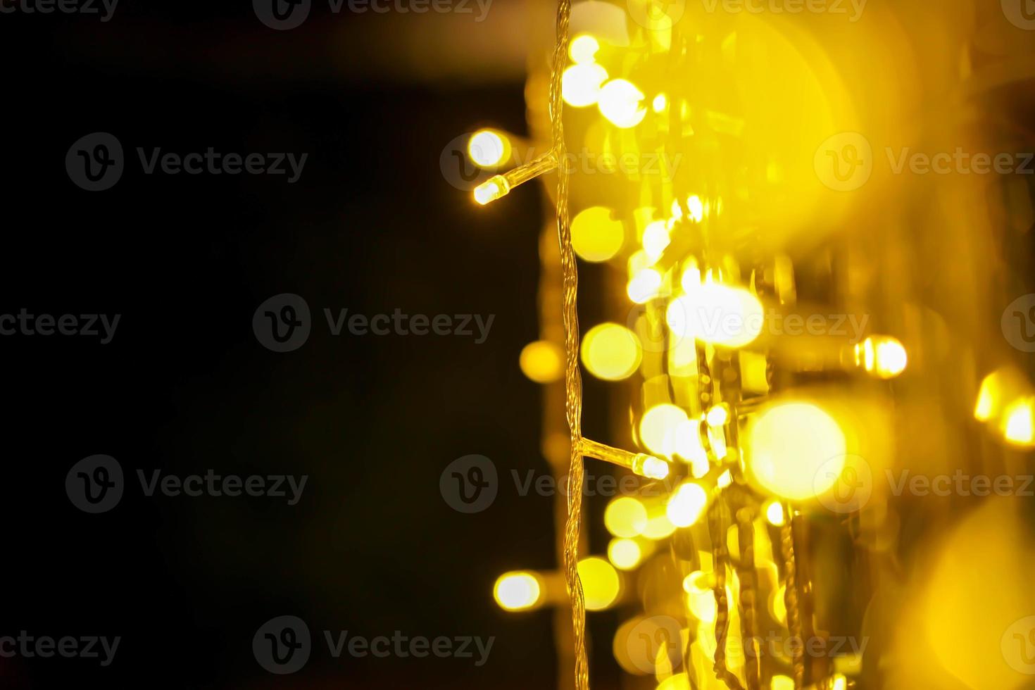 Closeup blurred and bokeh of Christmas lights and refection lighting on black background. photo