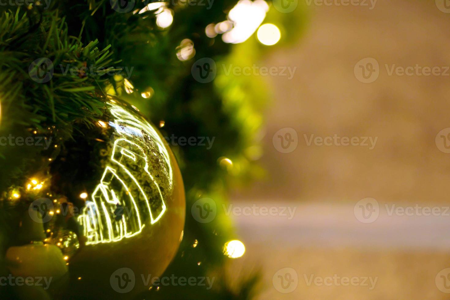 Closeup golden Christmas Balls Decorated on Pine Tree on Christmas day with bokeh of led lighting and blurry background. photo