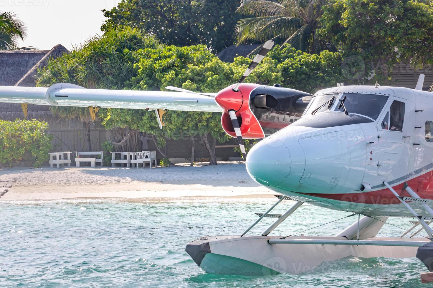 Exotic scene with seaplane on Maldives sea landing. Vacation or holiday in Maldives concept background photo