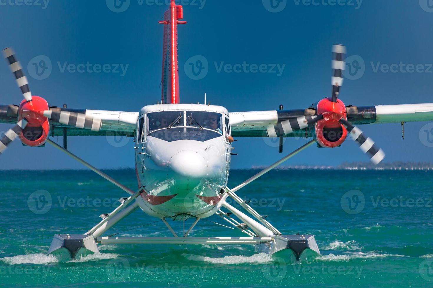 Exotic scene with seaplane on Maldives sea landing. Vacation or holiday in Maldives concept background photo