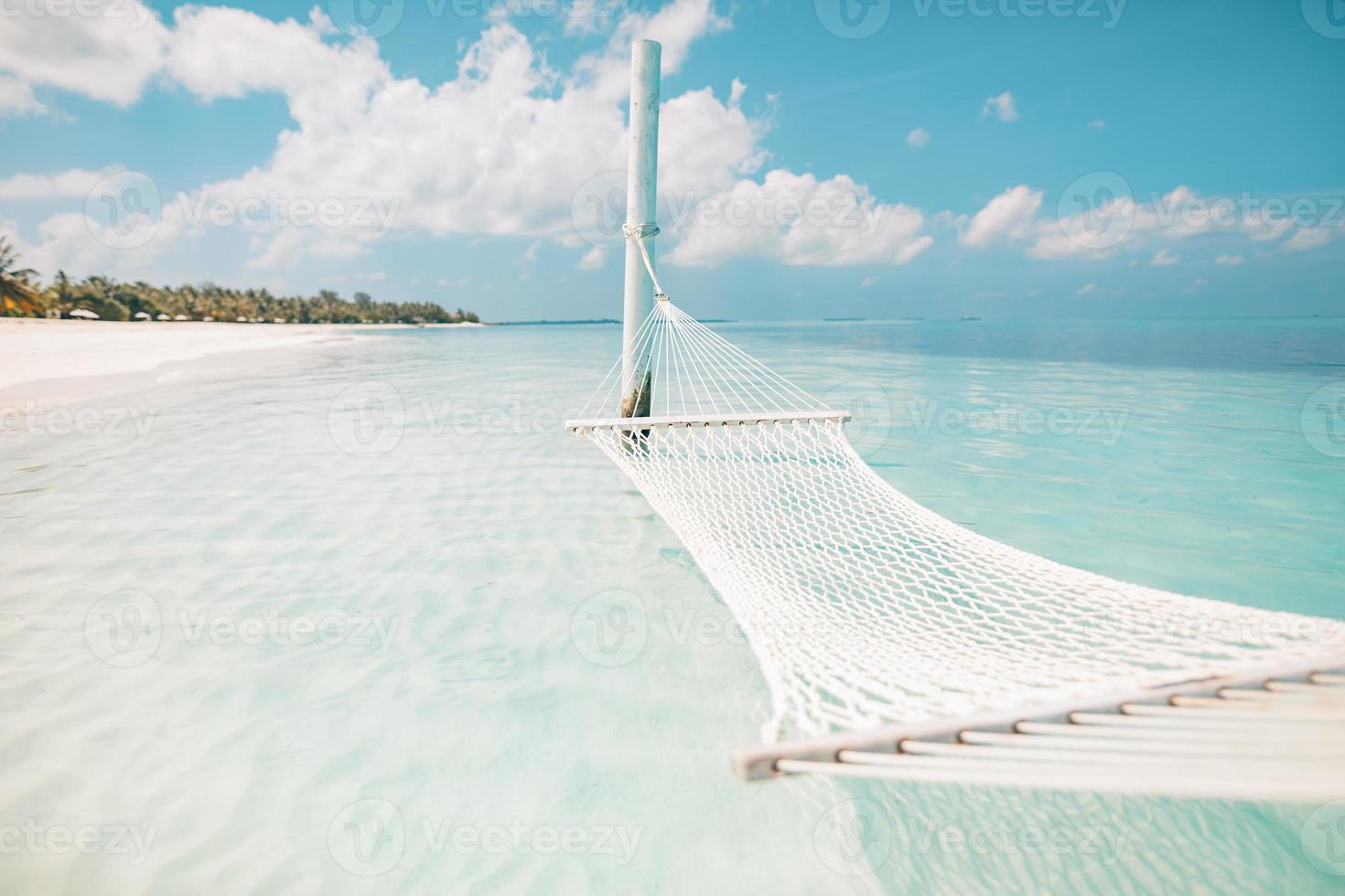 Summer vacations concept. Relaxing in hammock or swing on tropical beach at sunny day, amazing summer beach vacation and holiday background photo
