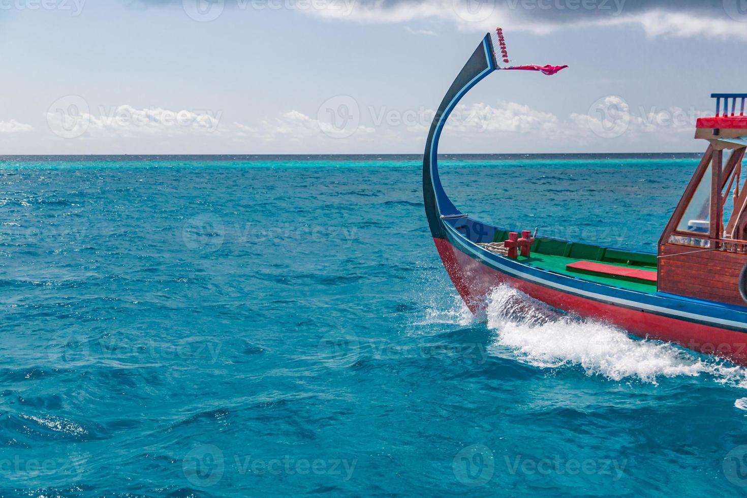 Maldivian dhoni boat in blue ocean background. Maldives traditional wooden boat called Dhoni. Tropical sea and wooden boat background photo