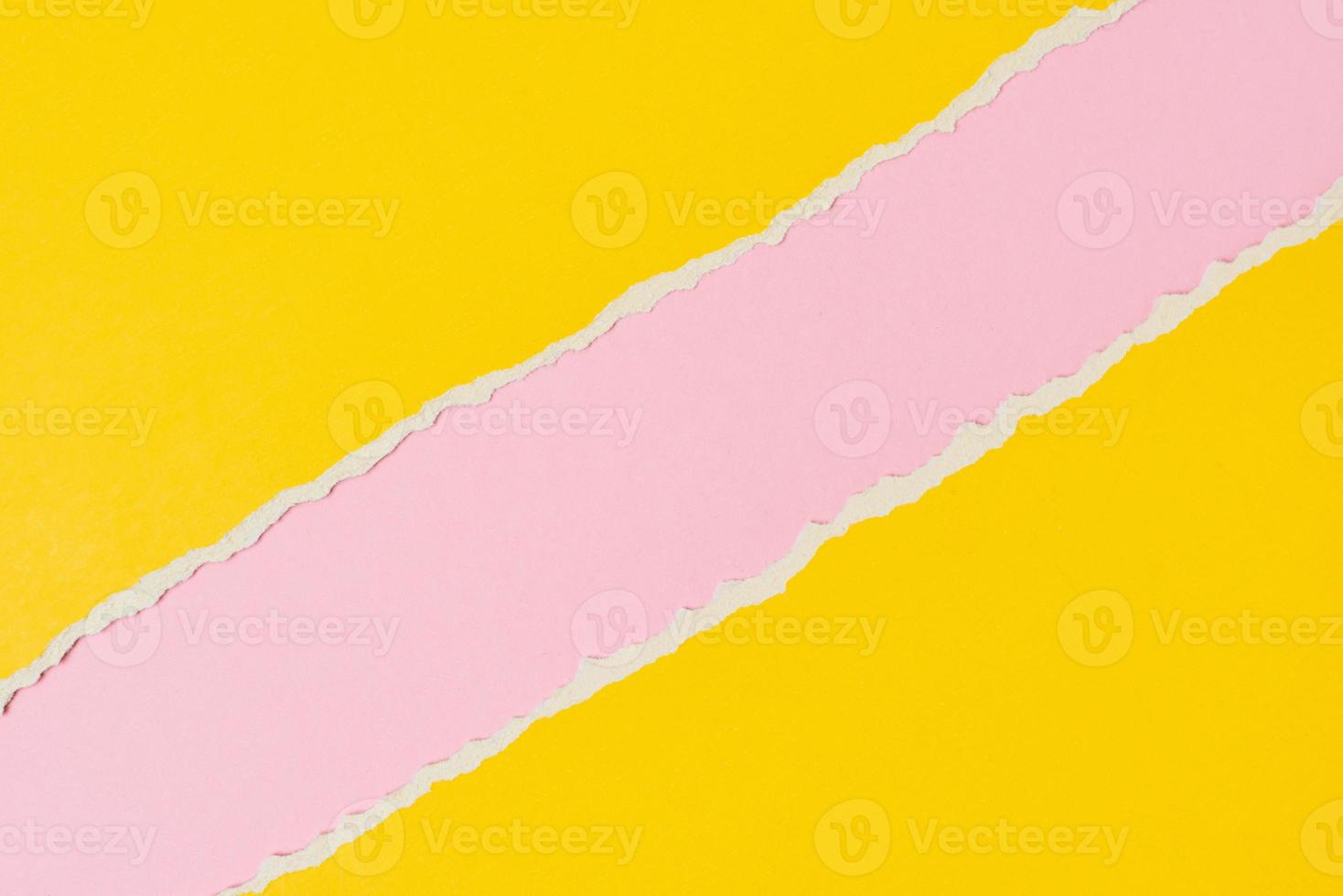 Torn ripped paper edge with a copy space, pink and yellow color background photo