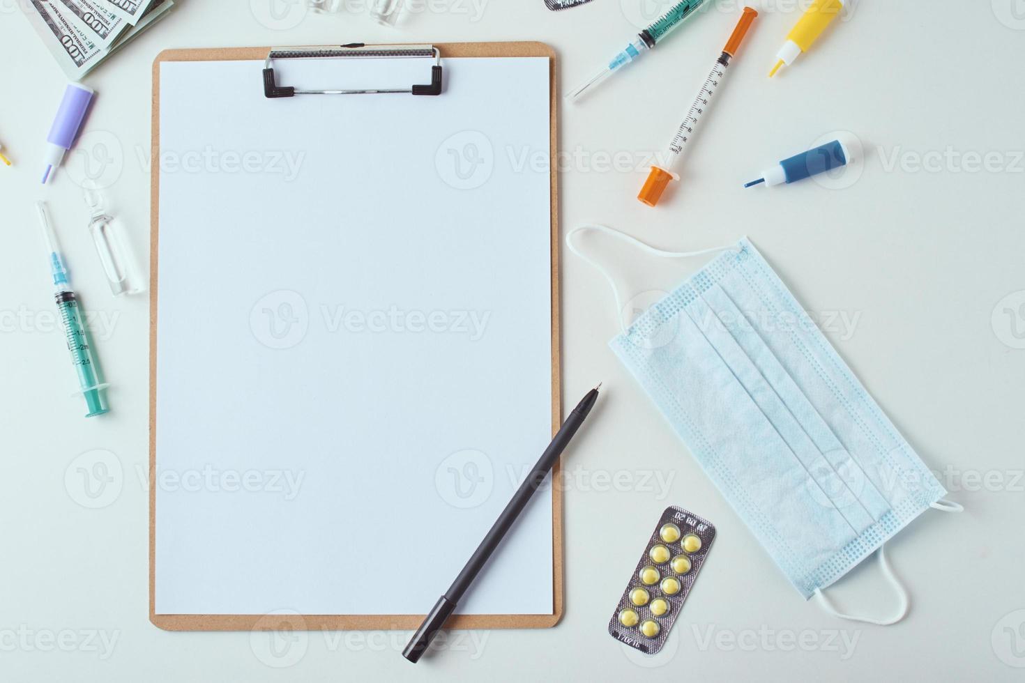 Top view of medical items and empty paper blank sheet on the white background photo