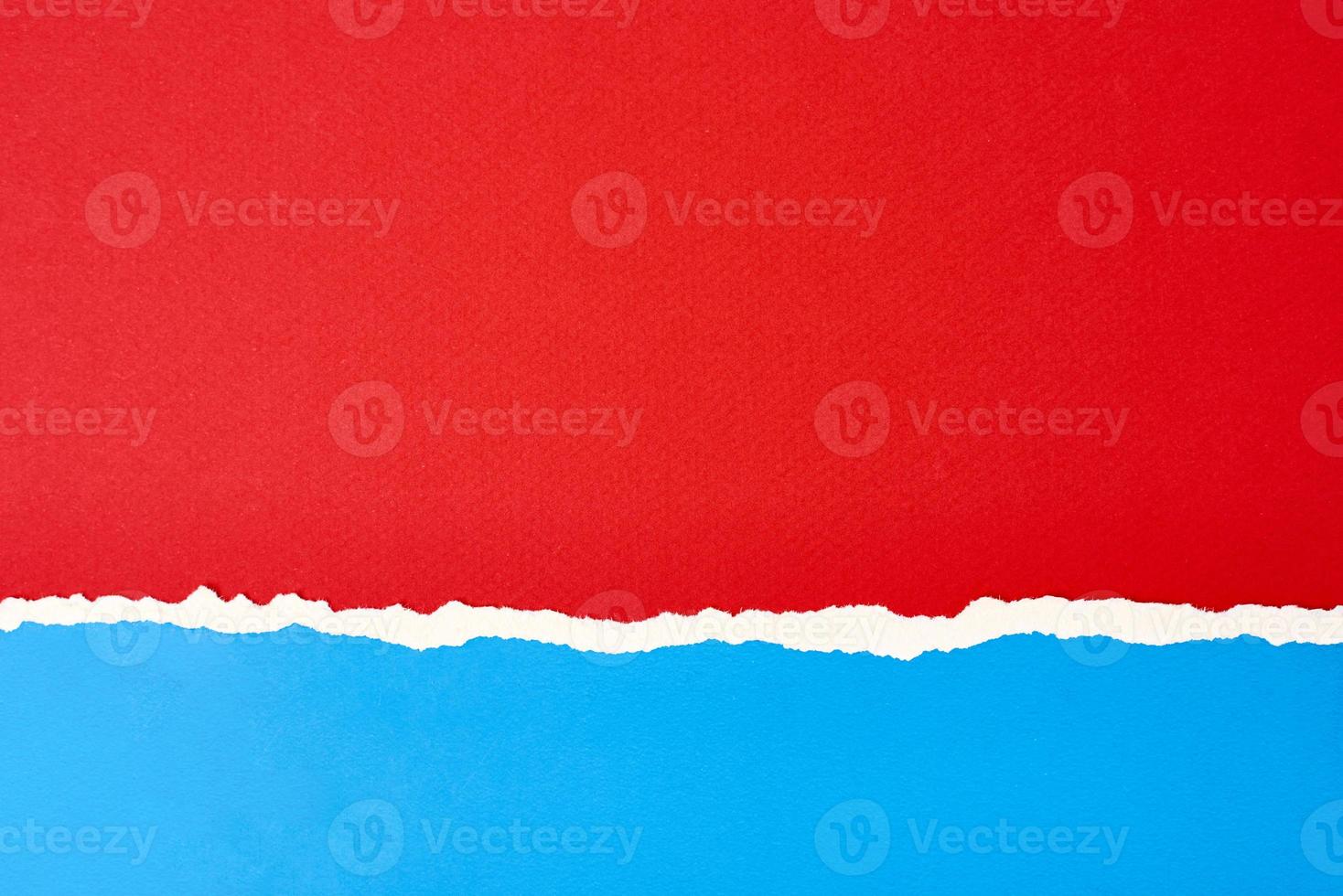 Torn ripped paper edge with a copy space, red and blue color background photo