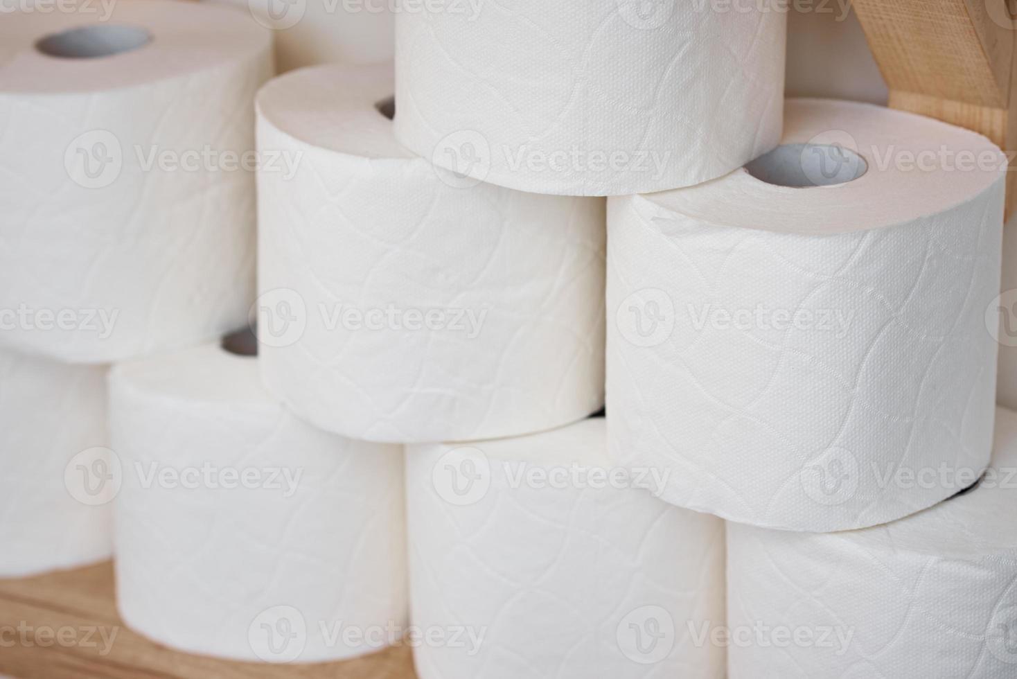 Stocks of toilet paper rolls on shelf photo