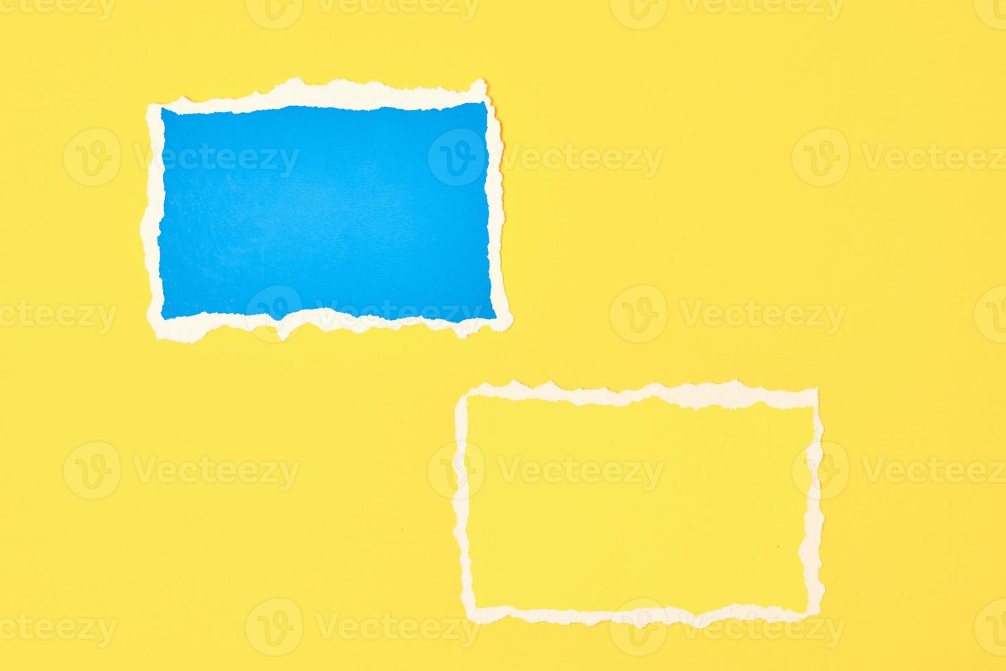 Two ripped paper torn edge sheets on a yellow background. photo