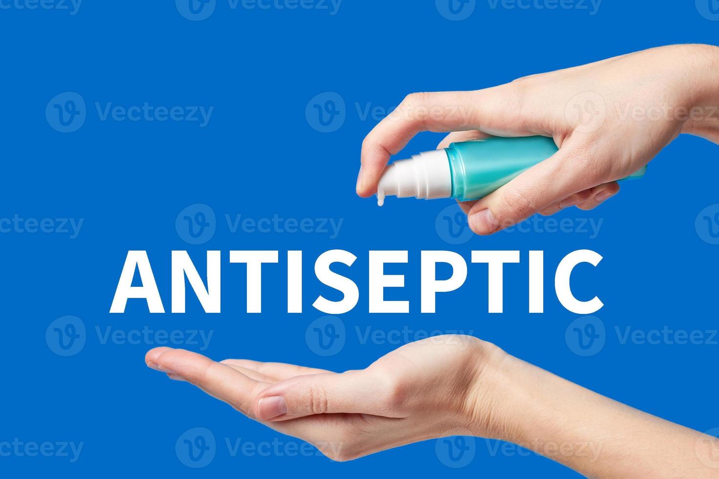 Woman hand using wash hand hygiene gel pump dispenser on a blue background, female skin care photo