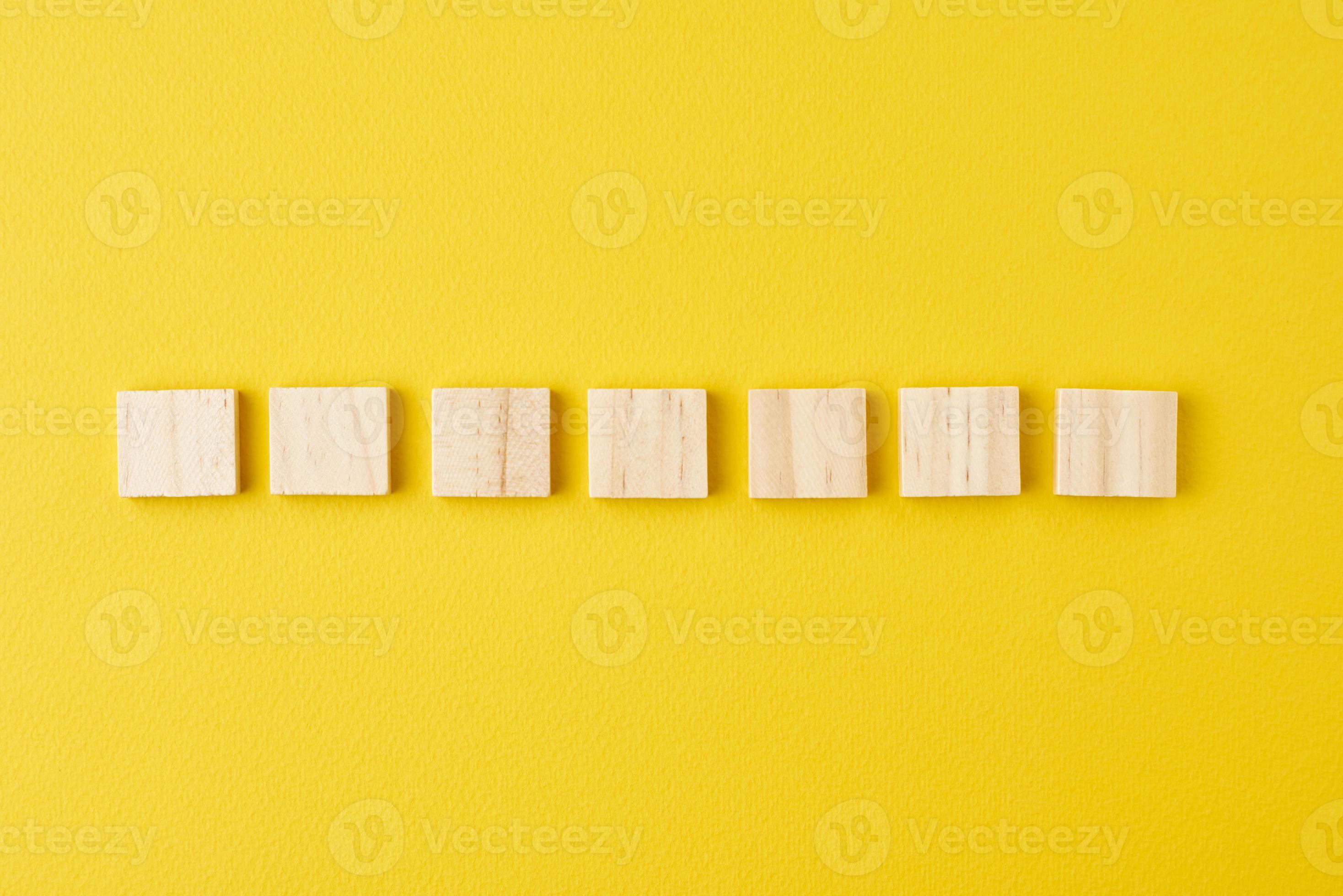 Wooden blocks in row on the yellow background, top view 15178716 Stock