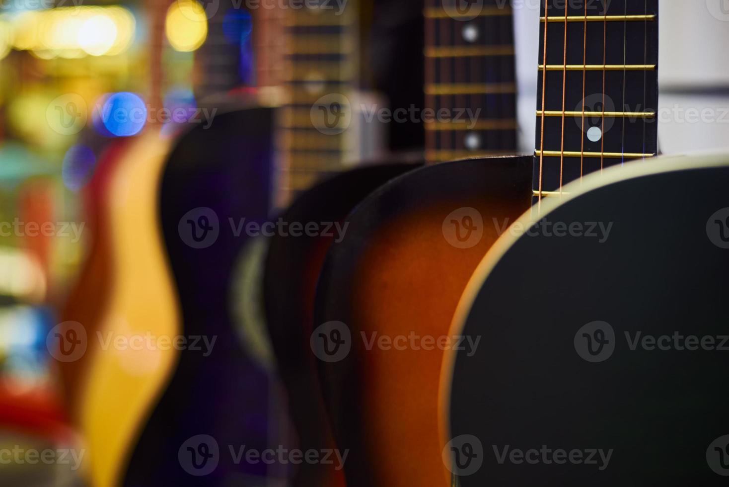 Row of classic acoustic guitars in the shop photo