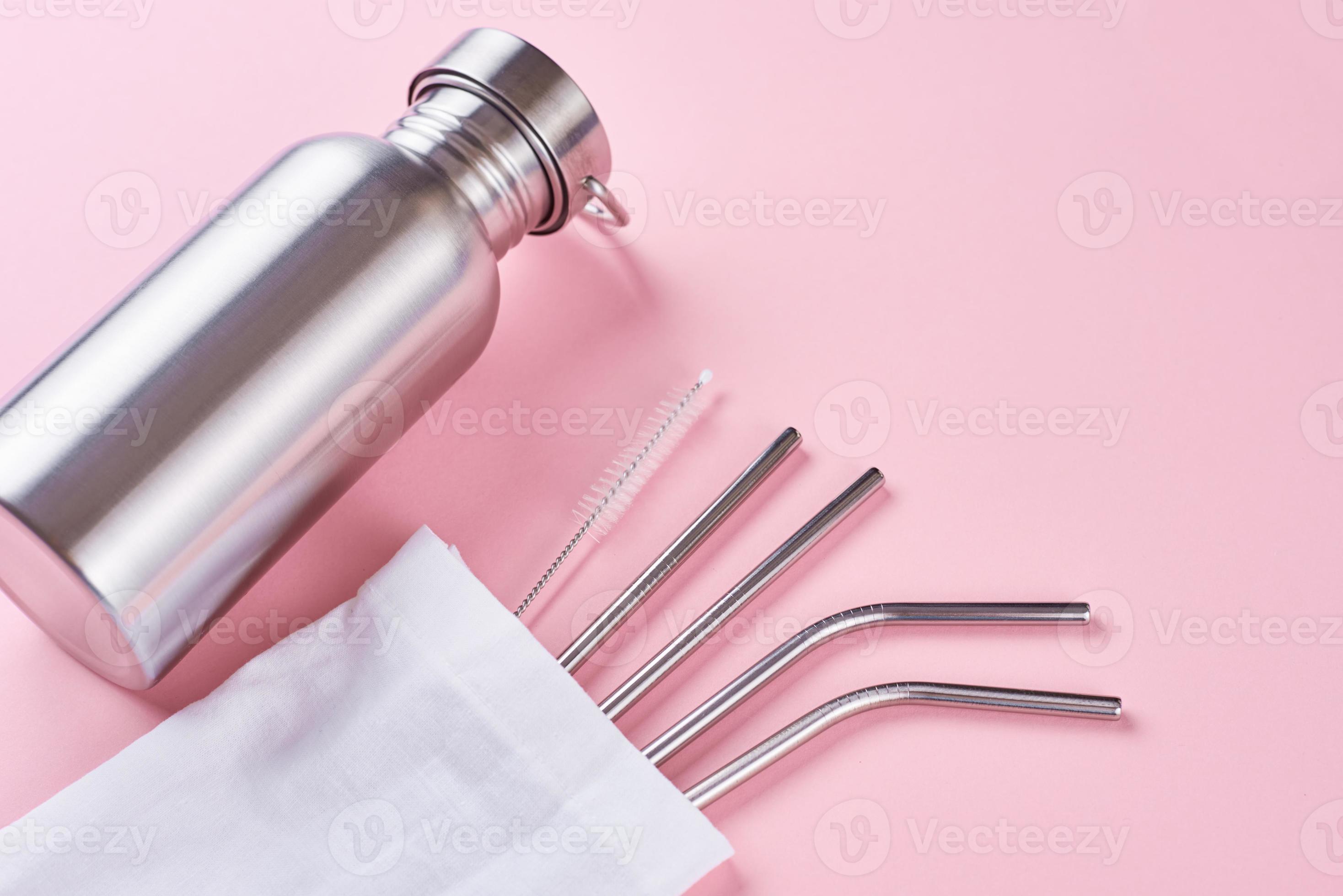 Reusable steel straws and aluminium bottle on pink background 15178932