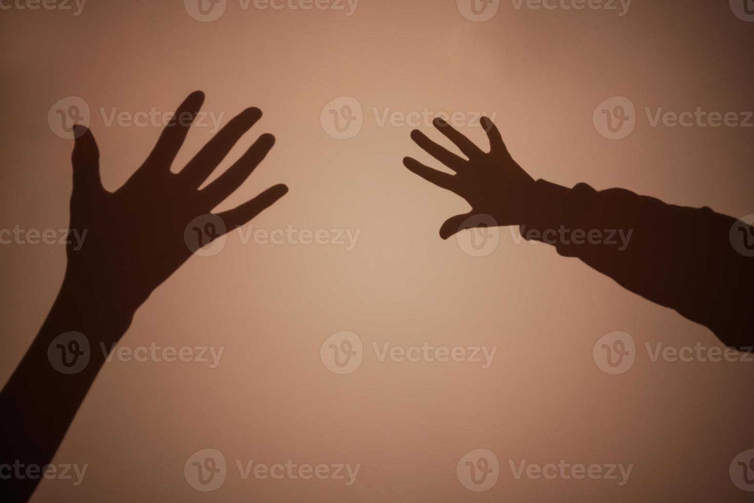 Shadow of the hand and fingers on the wall. photo