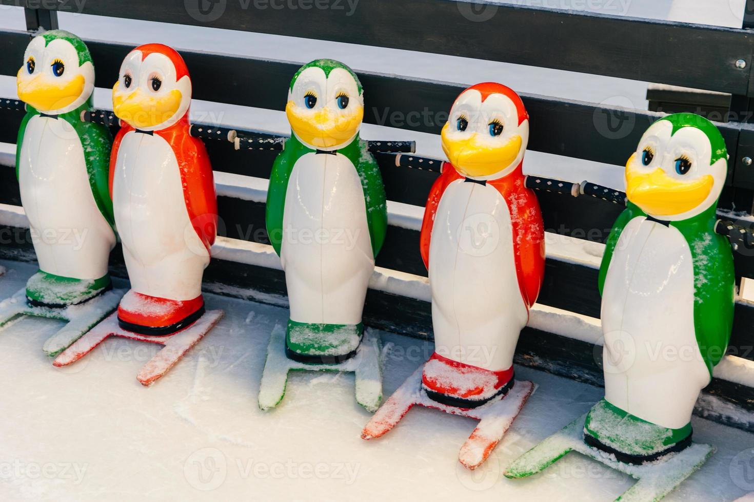 Shot of special equipment needed for skating, helping people to keep balance on ice rink. Helpers for skater beginners. Colourful figures in form of penguins photo