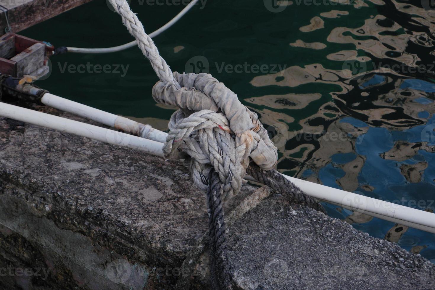 selectively focus on rope knots to tie fishing boats photo