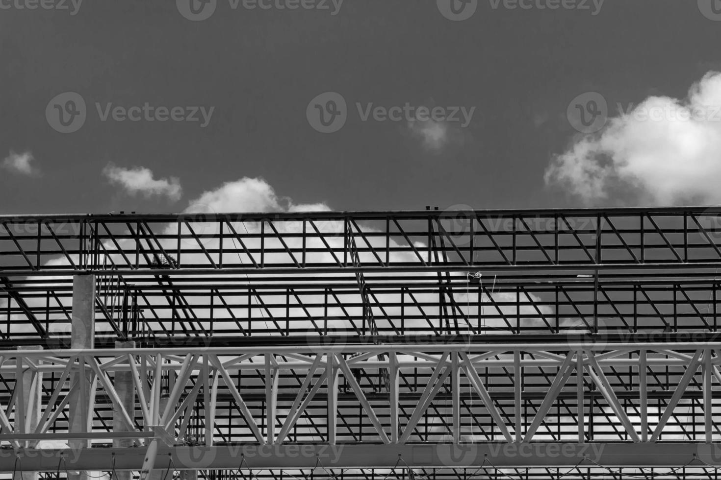 Heavy Steel Structural Gantry Crane for moving large slabs in a dangerous slab casting factory is being built strong and stable against a beautiful evening sky background. photo