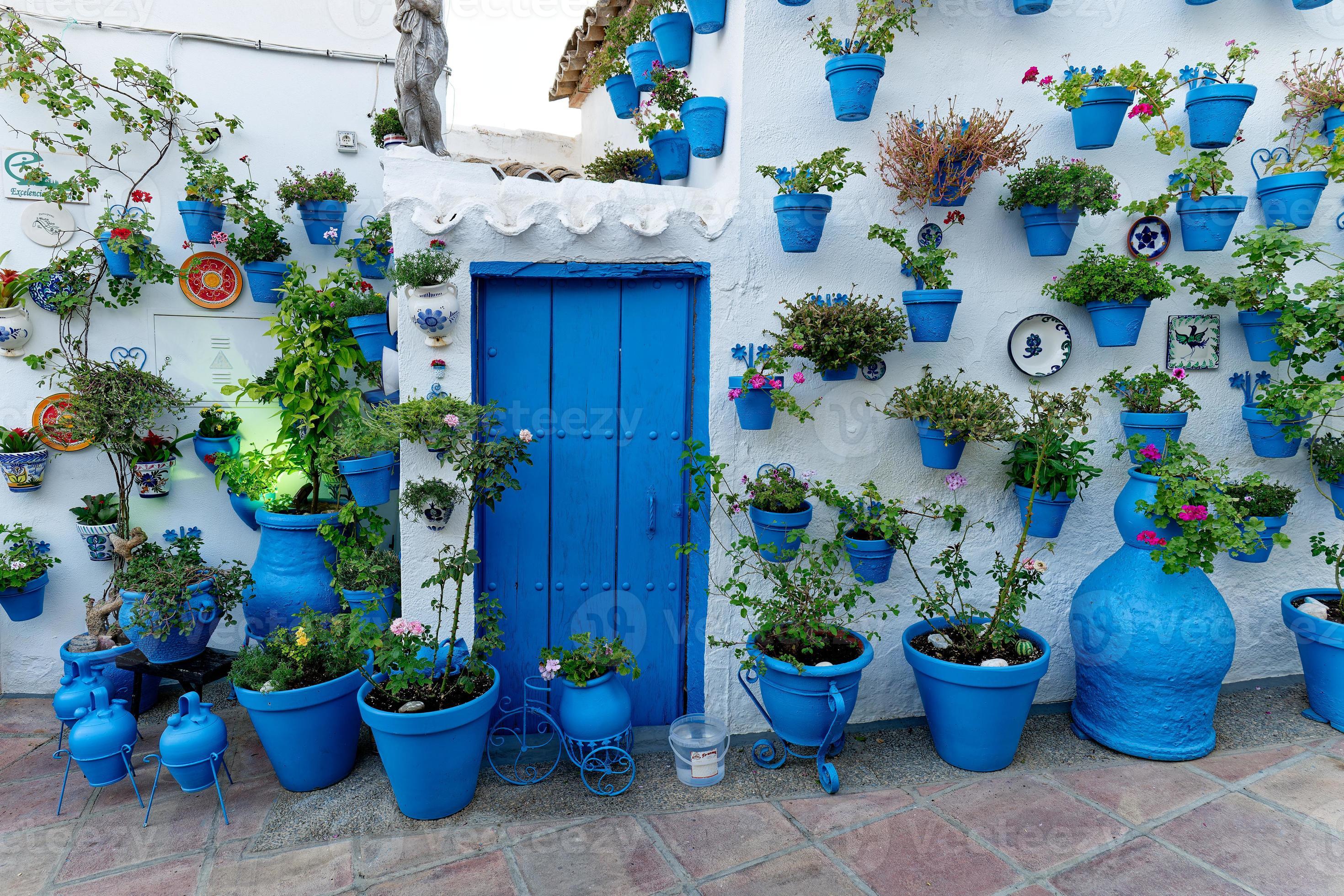 Decorated house with blue vases and flowers. Blue color. Stylish house