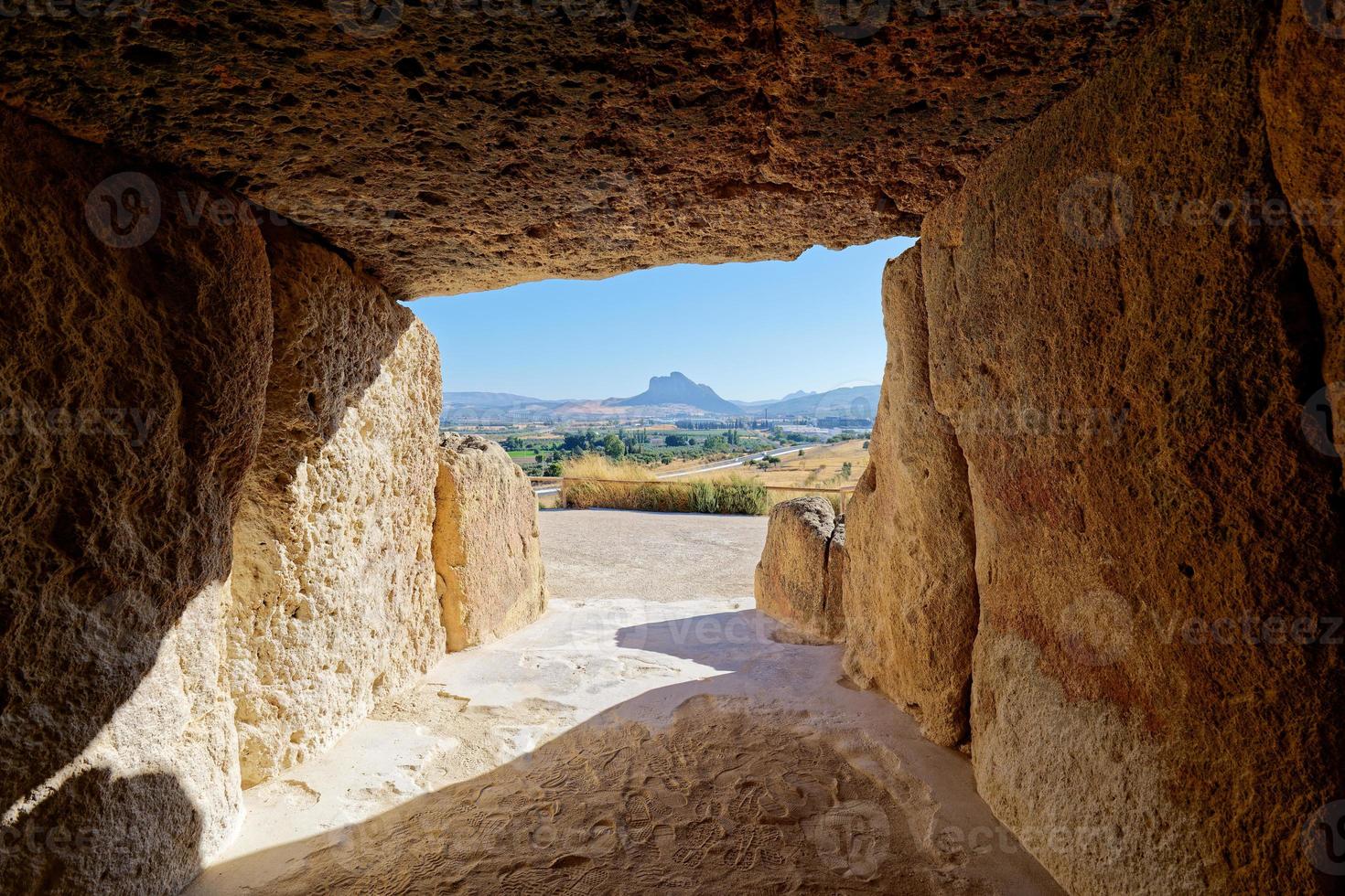 Interior of the megalithic monument Dolmens in Antequera with the natural monument The Lovers' Rock in the background. Touristic travel to Spain. Historic interest and Unesco World Heritage Site. photo