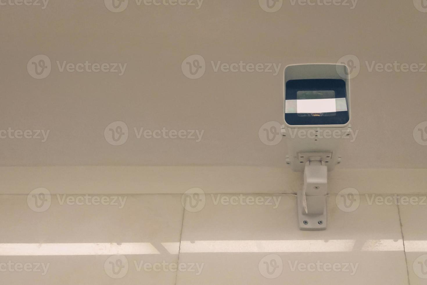 city video surveillance system - security camera under ceiling, front view photo