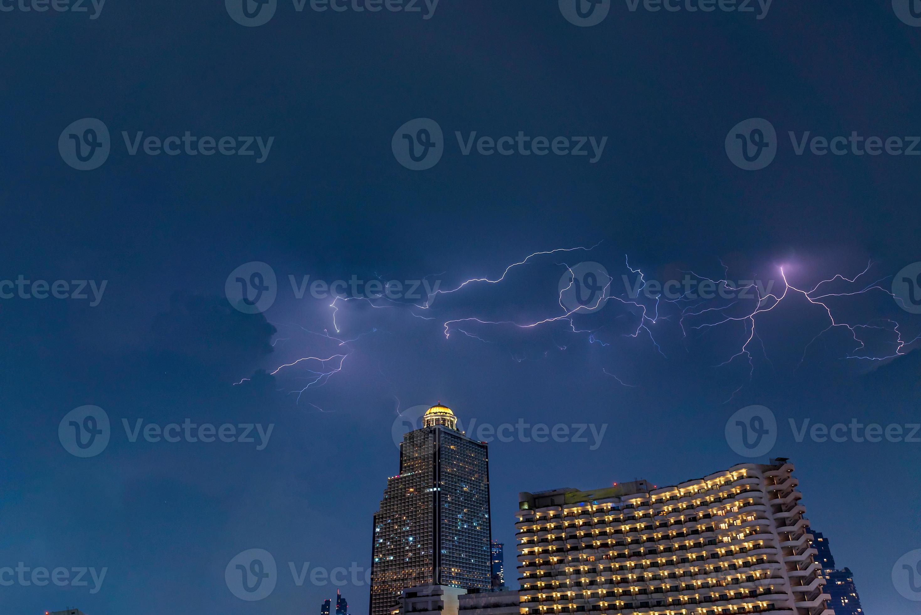 lightning strike over building area in Bangkok City at night, Thailand