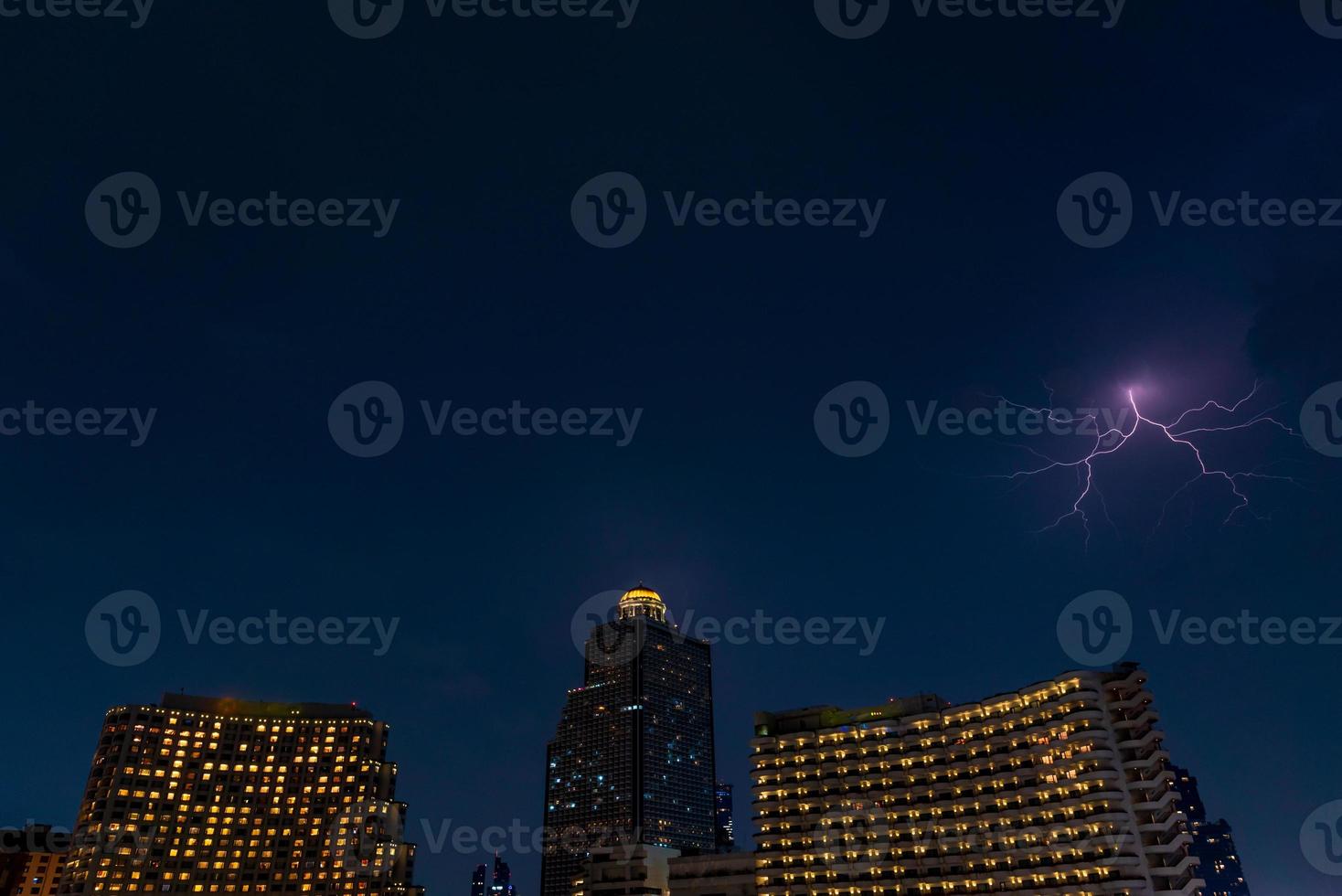 lightning strike over building area in Bangkok City at night, Thailand