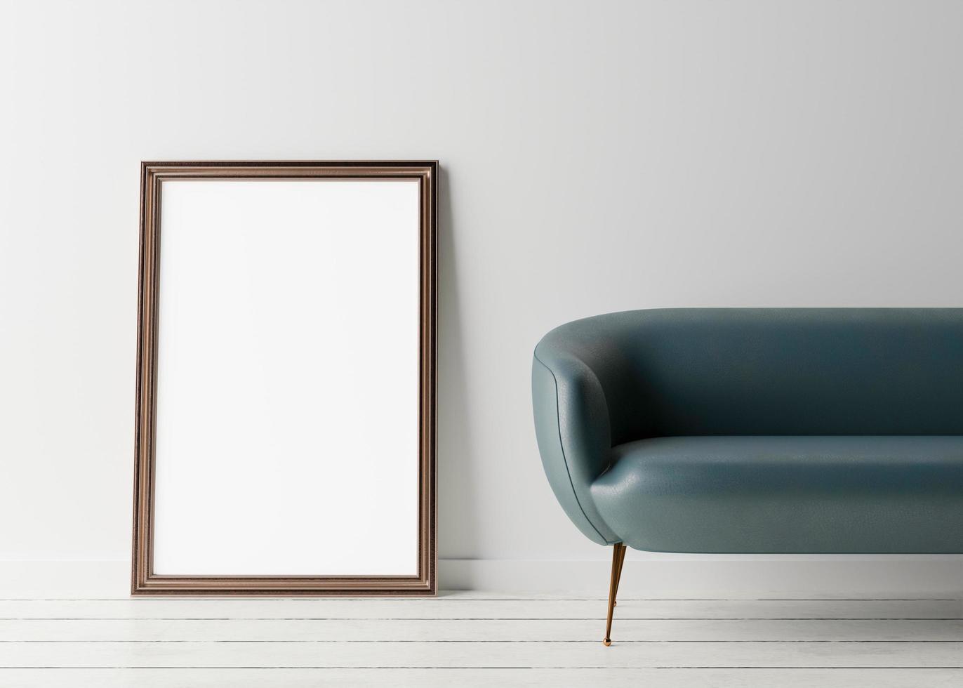 Empty vertical picture frame standing on the floor, with white wall and blue leather couch. Mock up interior in minimalist style. Free space, copy space for your picture or text. 3D rendering. photo