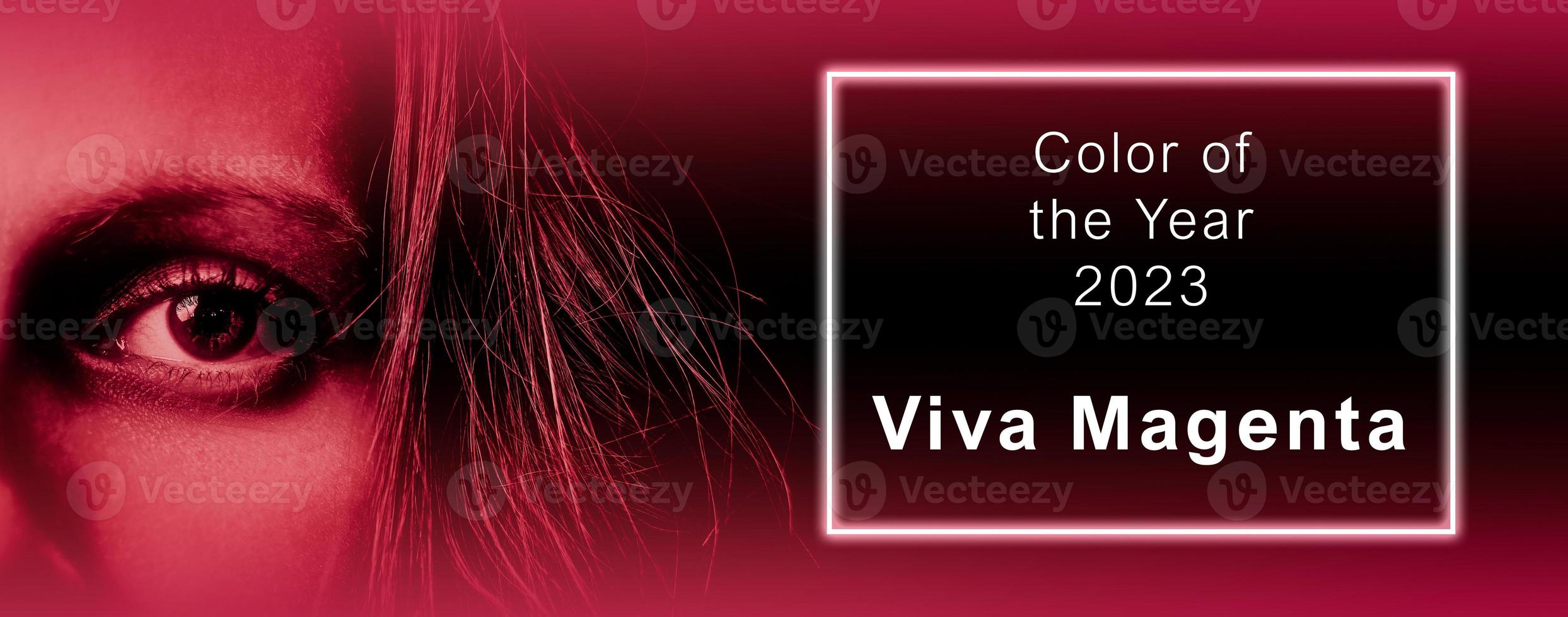 Viva Magenta - color of the year 2023. Trendy color sample. Toned picture with text. Beutiful banner with woman's eye. Fashion, style. photo