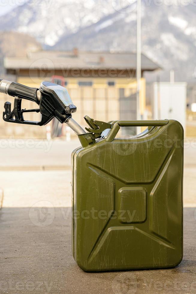 Refilling canister with fuel on the petrol station. Close up view. Fuel, gasoline, diesel is getting more expensive. Petrol industry and service. Petrol price and oil crisis concept. photo