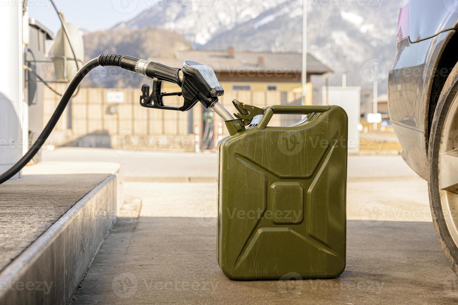 Refilling canister with fuel on the petrol station. Close up view. Fuel, gasoline, diesel is getting more expensive. Petrol industry and service. Petrol price and oil crisis concept. photo