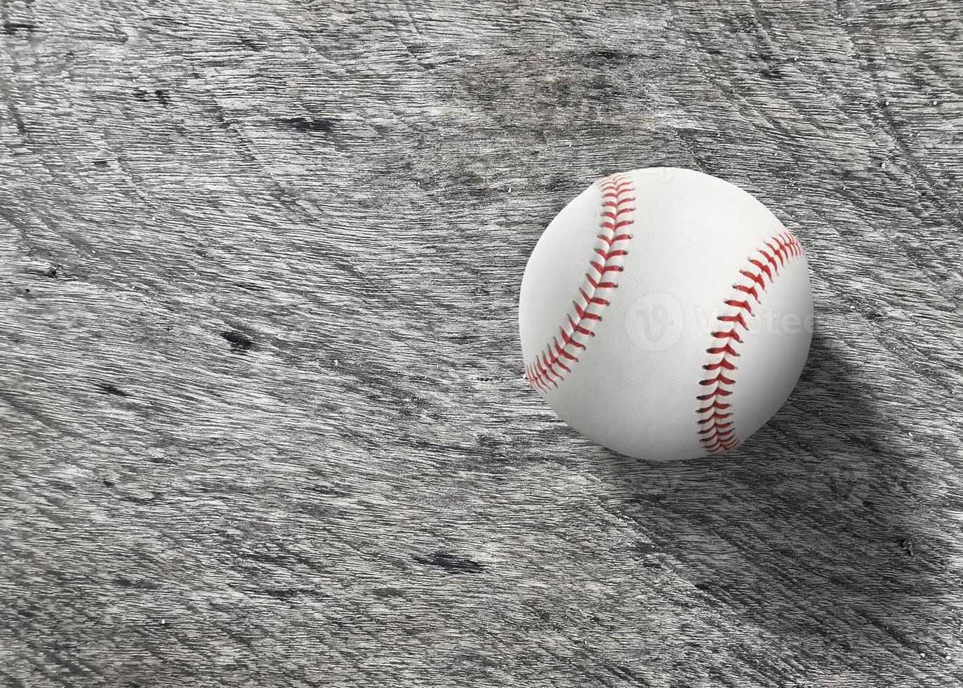 Baseball on wooden board turf close-up. Top view photo