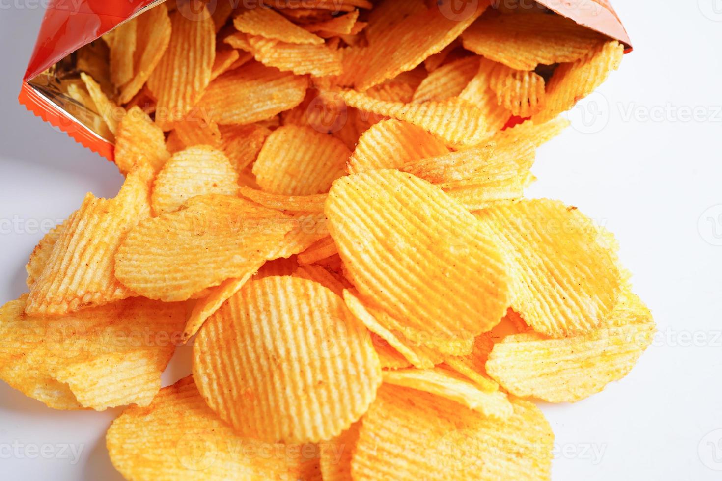 Potato chips in open bag, delicious BBQ seasoning spicy for crips, thin slice deep fried snack fast food. photo