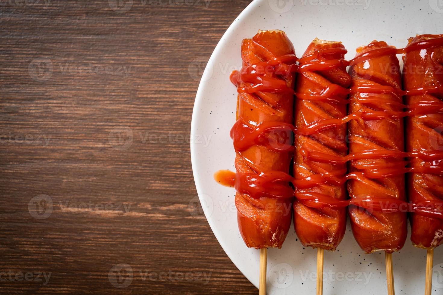 fried sausage skewer with ketchup photo