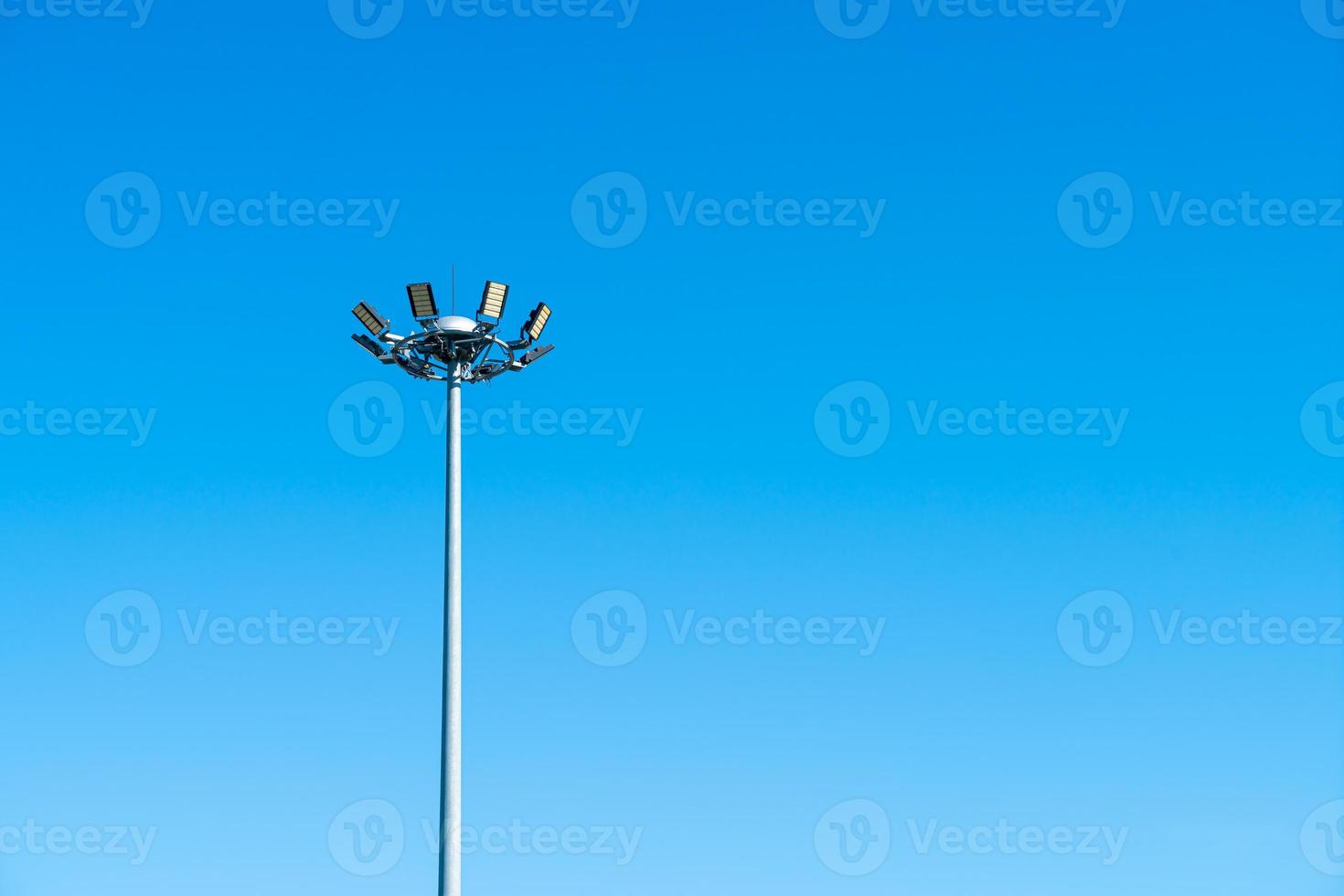 spotlight pole with blue sky photo